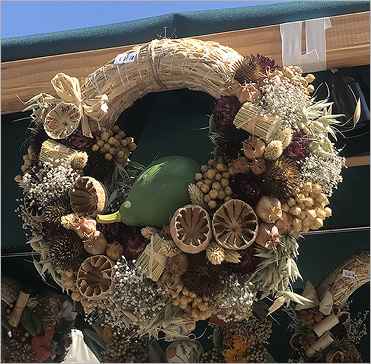photograph of dried poppy heads in a wreath