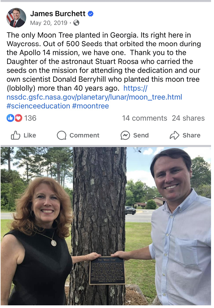 Image of a social media post containing text and a photograph of a woman and a man standing beside a pine tree trunk