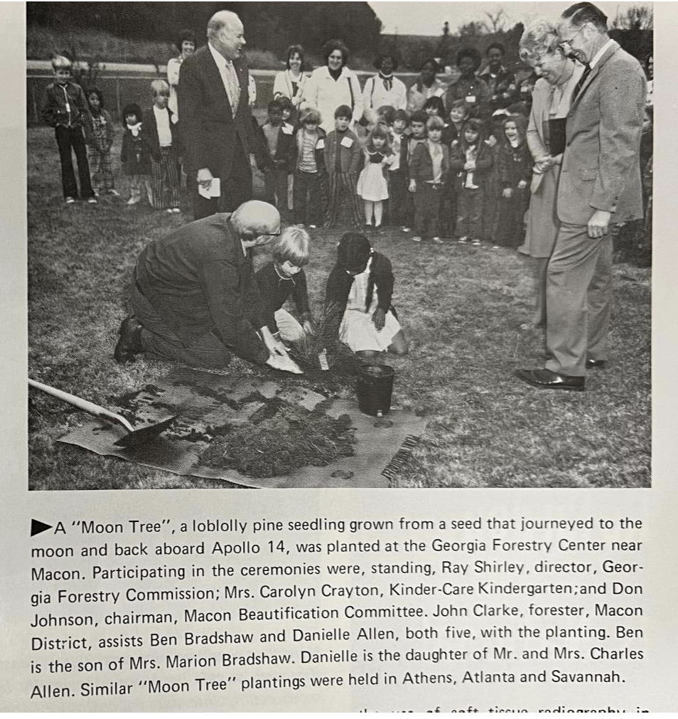 Black-and-white image of a newspaper clipping containing a photograph and text.